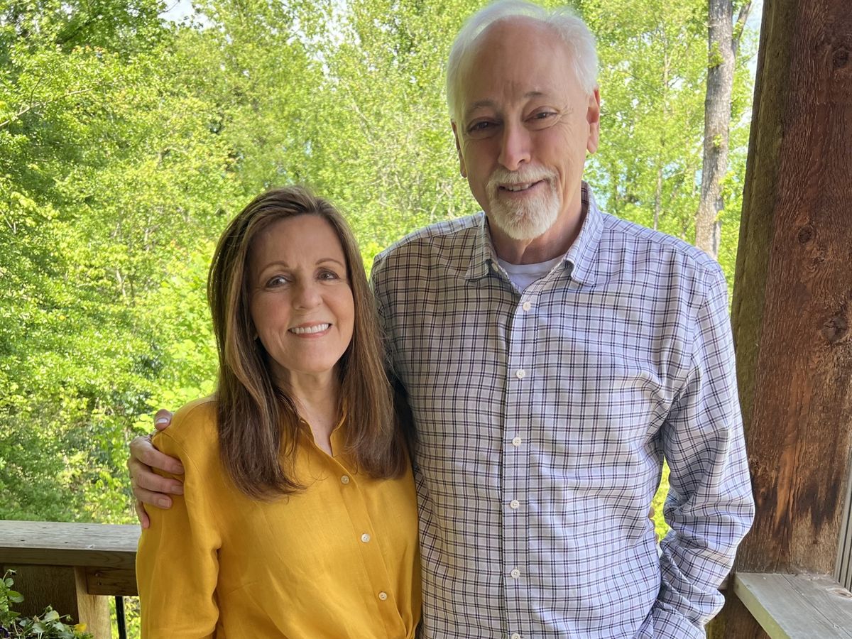Charlotte and Brian smiling on their deck